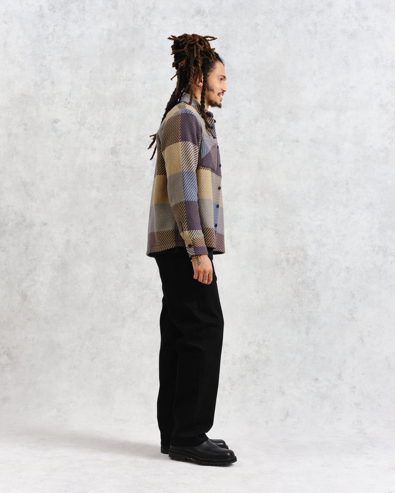 model facing side wearing multi colour square check overshirt